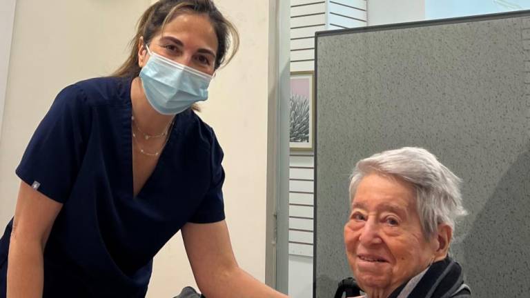 Ilana Yagudayev (left) a pharmacist and owner of Drug Mart on E. 86 Street and York Ave. administers a COVID booster shot to Helene Goldfarb at Assembly Member Rebecca Seawright’s in-office, no-cost clinic.