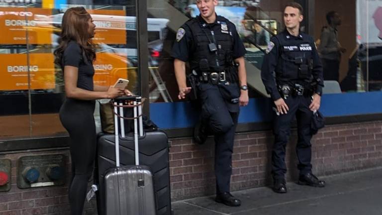 Port Authority Police Department cops talking to a female traveler outside the Port Authority Bus Terminal, 8th Ave., June 18, 2024. Around the corner on 42nd Street, passed out junkies and myriad volatile, desperate characters await.