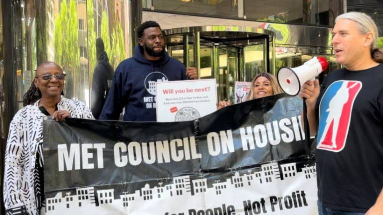 Greg Marshall (with mic) is with Bertha Lewis (far left) at a protest for affordable housing. Lewis founded The Black Institute, a leading organization in the Save Affordable Rent and “Blame Gary For It” campaign.